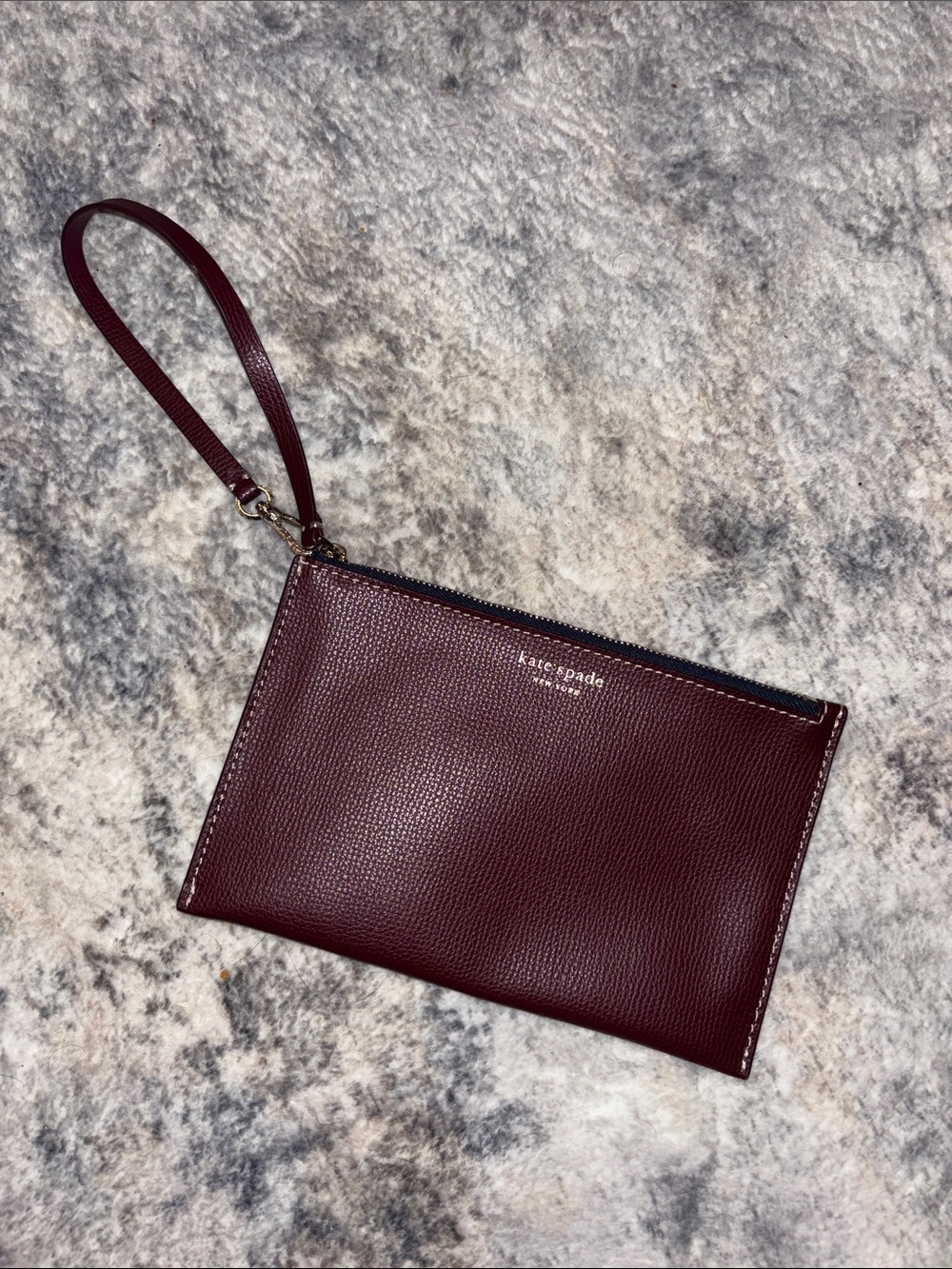 kate spade Pebbled Leather Wristlet in Burgundy with Gold Logo